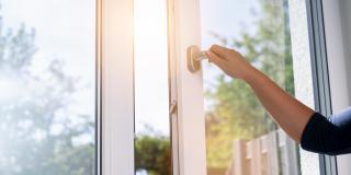 Symbolbild: Schutzmaßnahmen Radon. Eine Hand öffnet ein Fenster